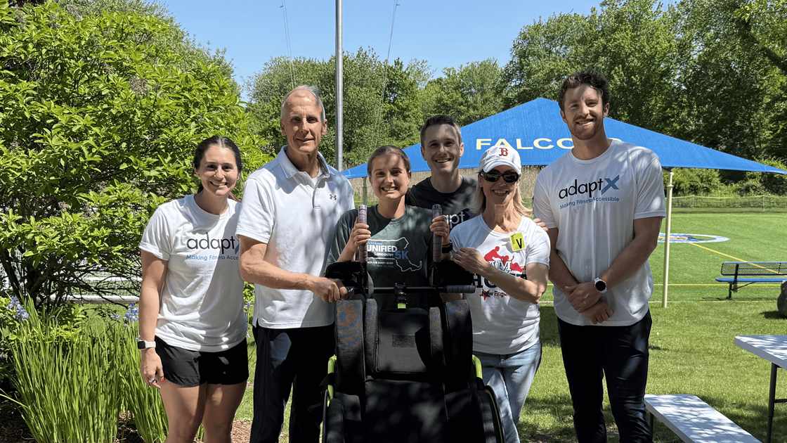 The AdaptX team and volunteers standing with a Hoyt running chair at the Cotting School demo day