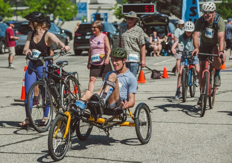 A handcyclist setting off alongside cyclists at the start