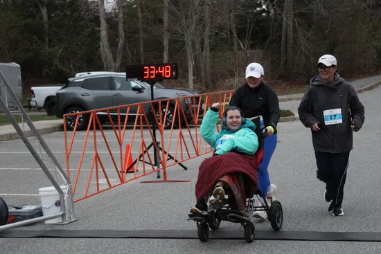 Claire finishing the race to applause from the crowd