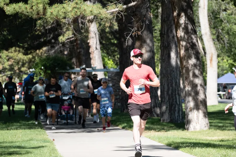 A runner on the shaded path through Liberty Park