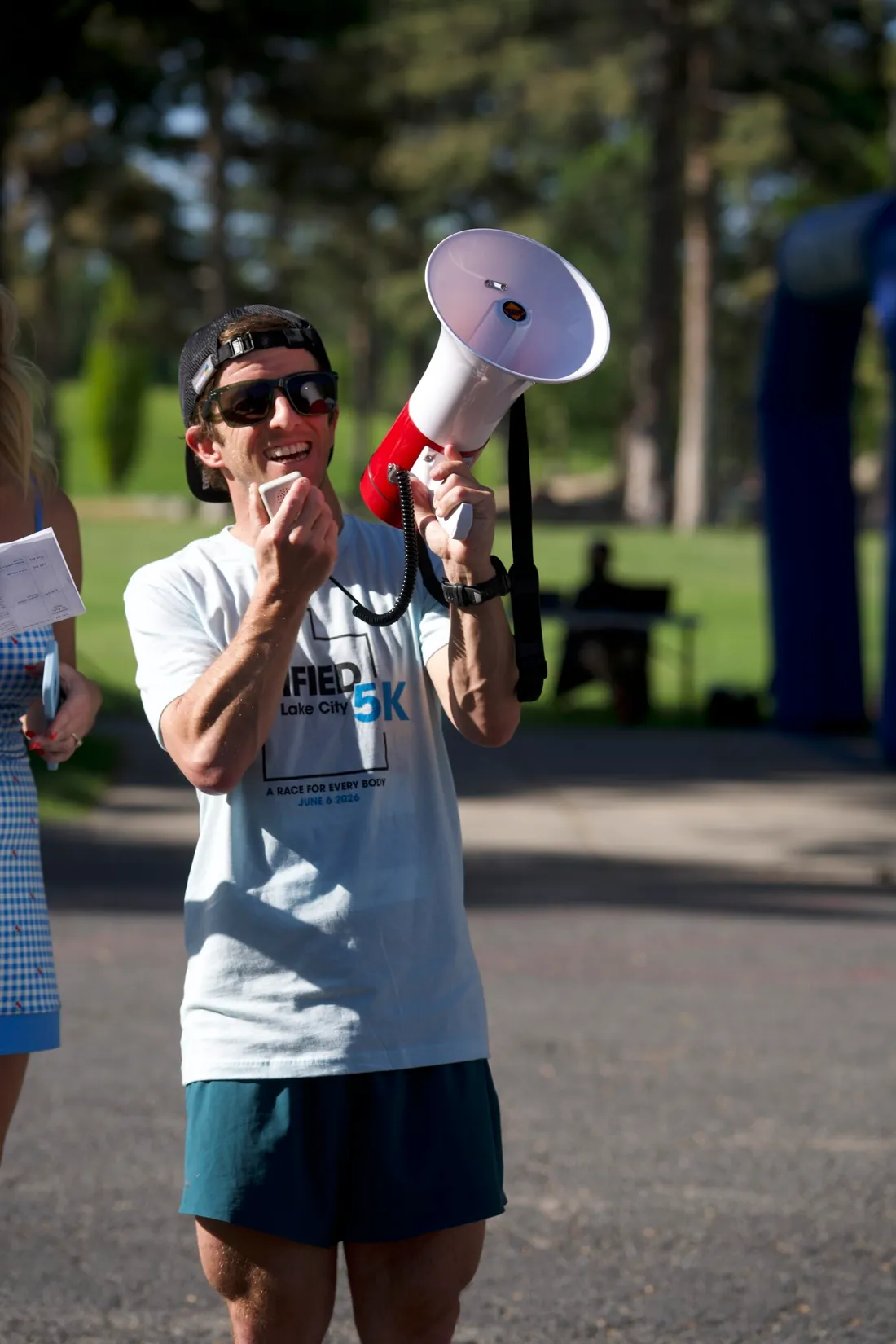 A volunteer calling runners on through a megaphone