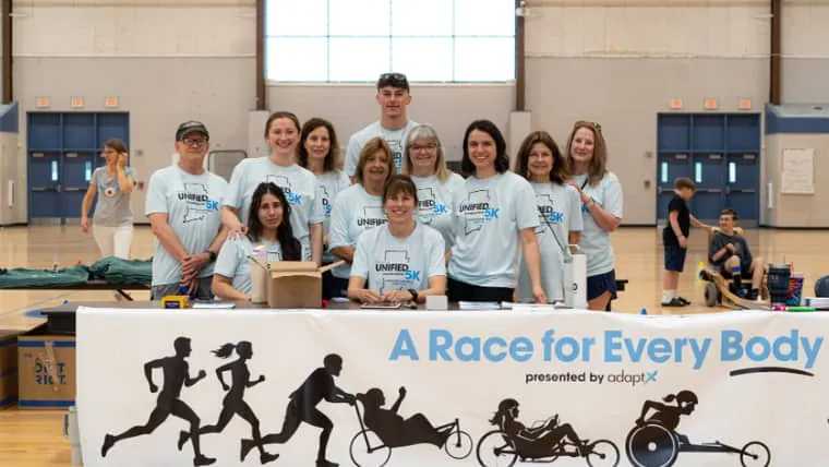Volunteers handing out water on a Unified 5K course