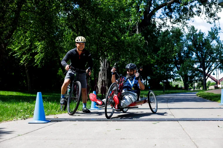 Handcyclists rounding a cone on the course