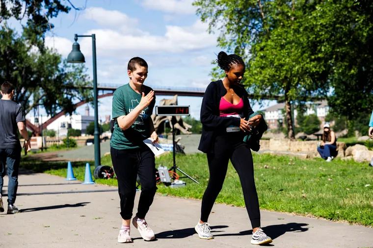 Two participants walking the course together by the river